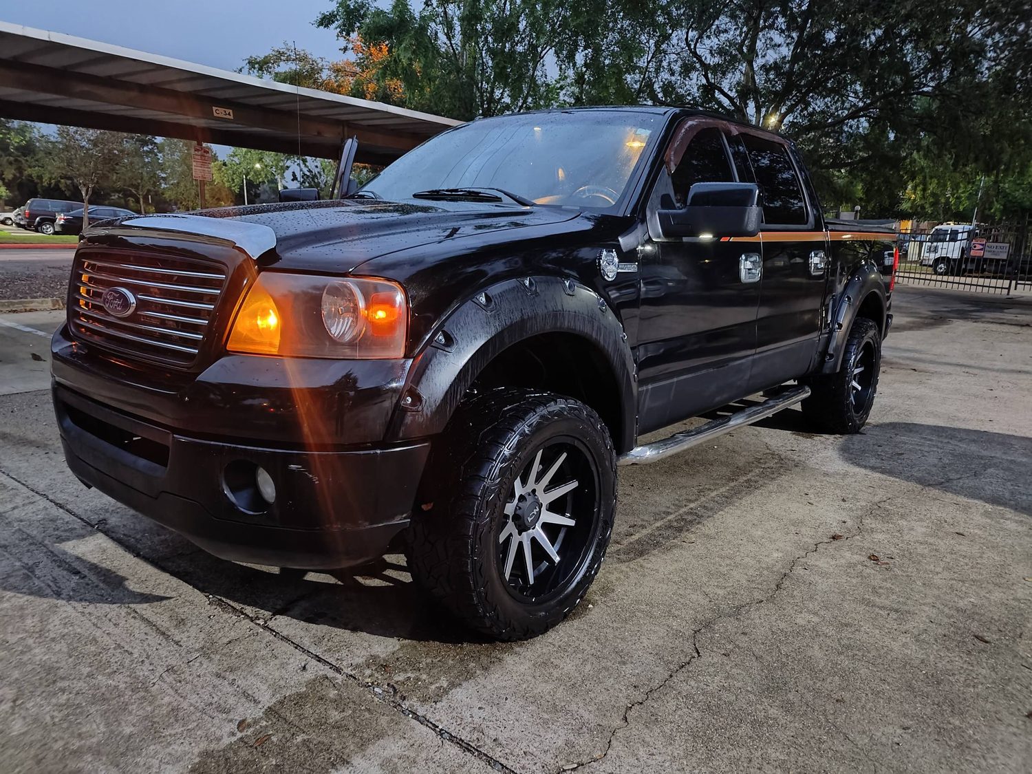 Black lifted Ford F-150 truck for sale at PS Auto Solutions in Katy, TX